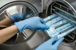 dentist in Weatherford putting instruments in an autoclave