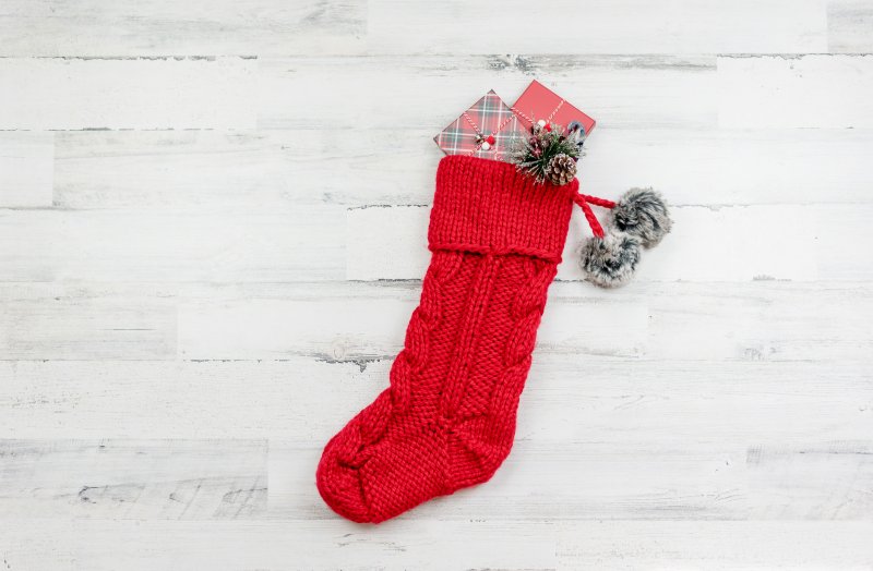 a single, red holiday stocking filled with small presents